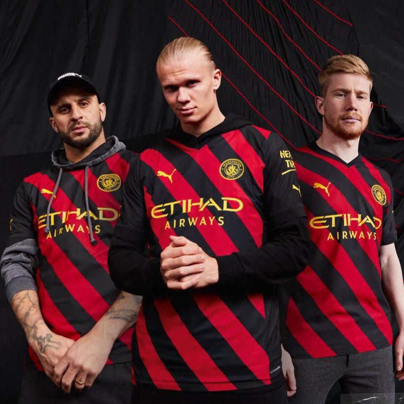Erling Haaland, Kyle Walker and Kevin de Bruyne models Manchester City's away kit
