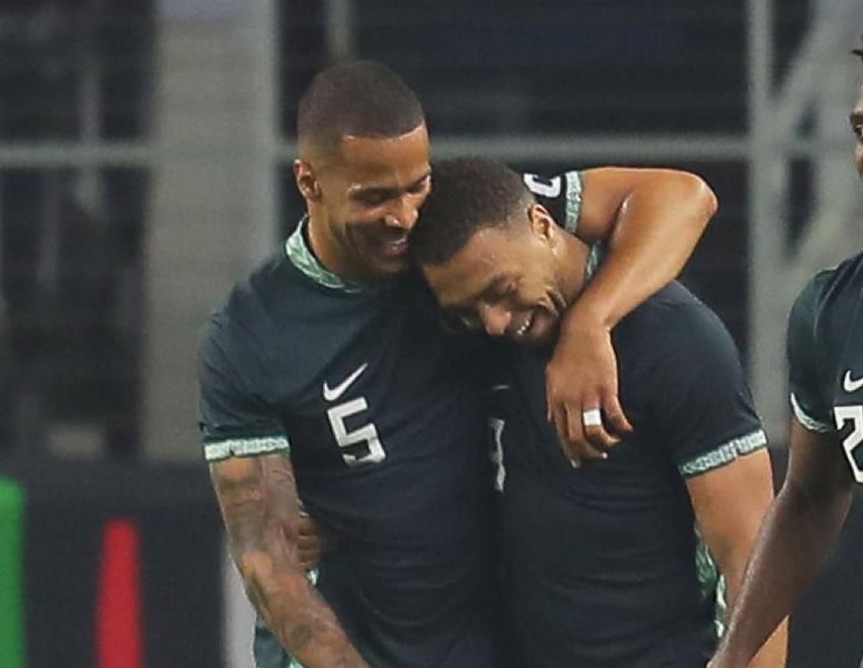 Troost-Ekong congratulates Dessers after his first goal for Nigeria.