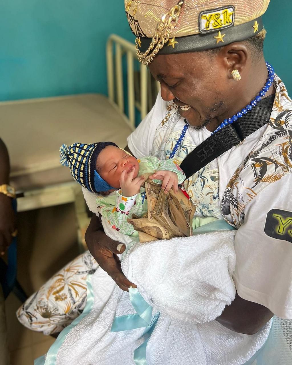 Nigerian singer Habeeb Okikiola, popularly known as Portable and his baby [Instagram/PortableDrZeh]