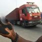 A man holds out his soot covered hand to illustrate how much soot covered the bonnet of his car in Port Harcourt