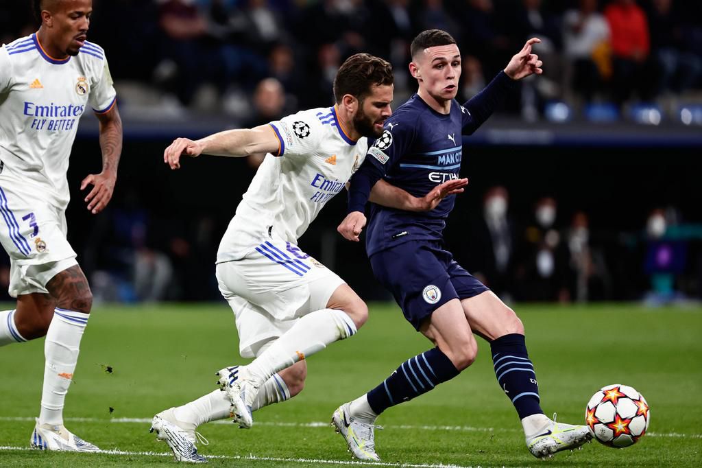 Phil Foden battles for the ball with Nacho Fernandez