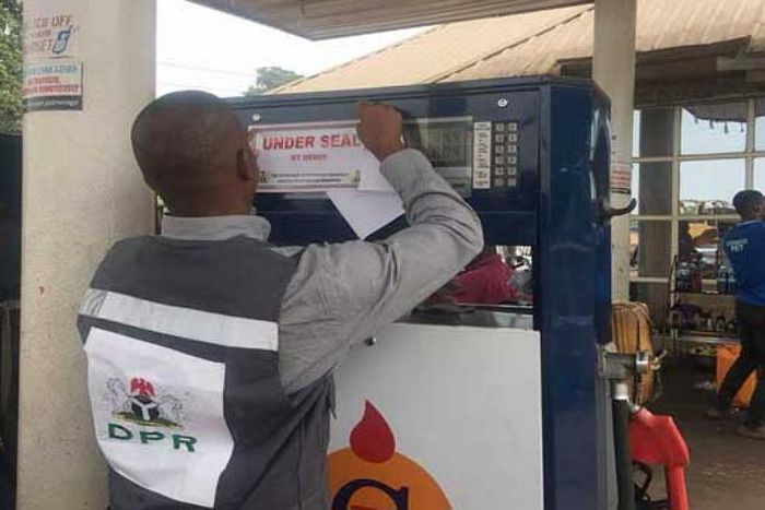 An official of the Department of Petroleum Resources (DPR) sealing off a filling station for violation of due process. [concisenews]