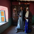 Groom Mohammed Boudad stands with his wife, Habiba Ajdir, inside their house that was damaged in the aftermath of the 6.8 magnitude earthquake, in Kettou village, Morocco September 12, 2023. [REUTERS/Emilie Madi]