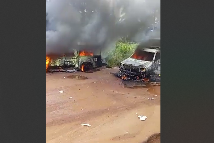 The vehicles of the security operatives after the assailants set them on fire. [Punch]