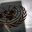 The United Nations headquarters building is pictured though a window with the UN logo in the foreground in the Manhattan borough of New York August 15, 2014. REUTERS/Carlo Allegri