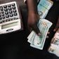 A trader changes dollars for naira at a currency exchange store in Lagos, Nigeria, February 12, 2015.   REUTERS/Joe Penney/File Photo