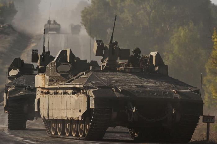 Israeli army armoured vehicles rolled towards the border with the Gaza Strip at an undisclosed location in southern Israel on October 15, 2023.YURI CORTEZ/AFP via Getty Images
