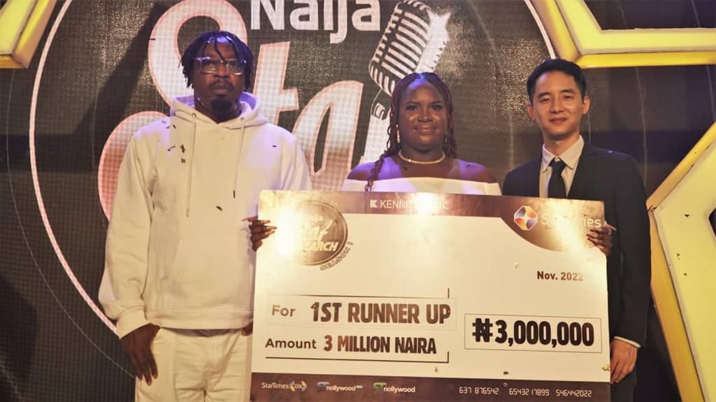 Eniola receiving her cheque