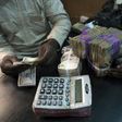 A trader changes dollars with naira at a currency exchange store in Lagos, Nigeria in this February 12, 2015 file photo.