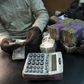 A trader changes dollars with naira at a currency exchange store in Lagos, Nigeria in this February 12, 2015 file photo.