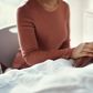 A woman holds a patients hand at a hospital.shapecharge/Getty Images