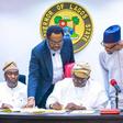 Gov. Babajide Sanwo-Olu of Lagos State (middle) signing the Y2023 Appropriation bill into law at the Conference room of Lagos House, Alausa, Ikeja, on Friday, Jan. 27, 2023. With him are Deputy Governor, Dr Obafemi Hamzat (left); Attorney General/Commi...