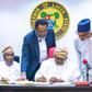 Gov. Babajide Sanwo-Olu of Lagos State (middle) signing the Y2023 Appropriation bill into law at the Conference room of Lagos House, Alausa, Ikeja, on Friday, Jan. 27, 2023. With him are Deputy Governor, Dr Obafemi Hamzat (left); Attorney General/Commi...