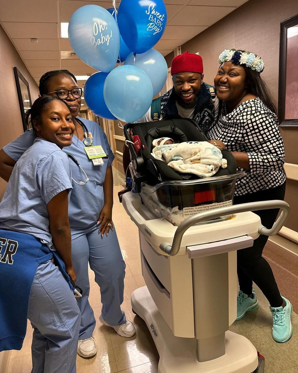 Stan and Blessing happily posing for pictures with their newborn [instagram/Stan Nze]