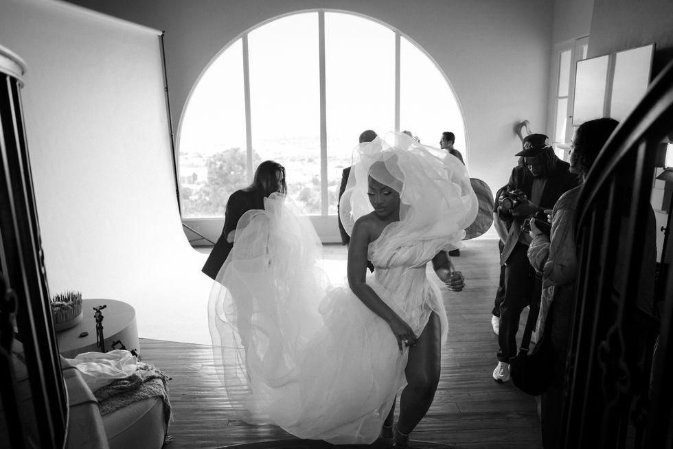 Tems getting ready with her team [Bazaar]