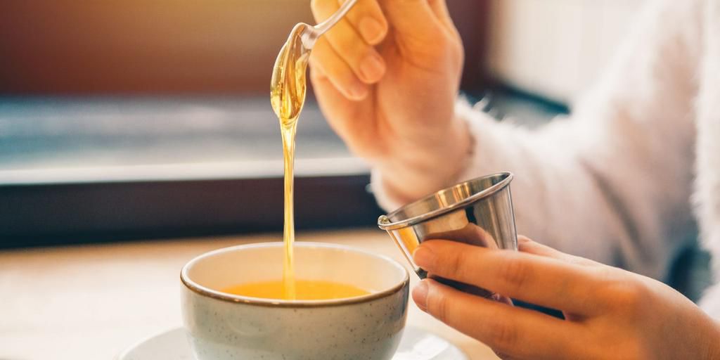Hot tea with honey and lemon can soothe a sore throat.Vera_Petrunina/Getty Images