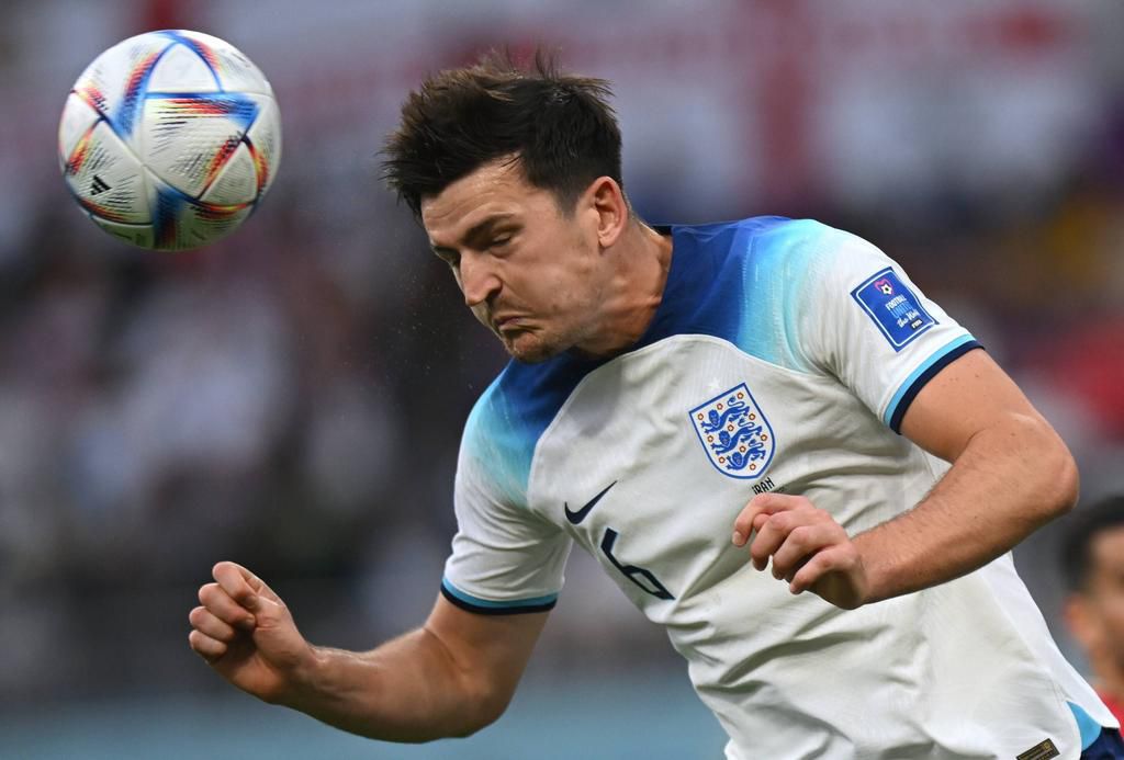 Harry Maguire heads a ball during the Qatar 2022 World Cup Group B soccer match between England and Iran at the Khalifa International Stadium in Doha on November 21, 2022.