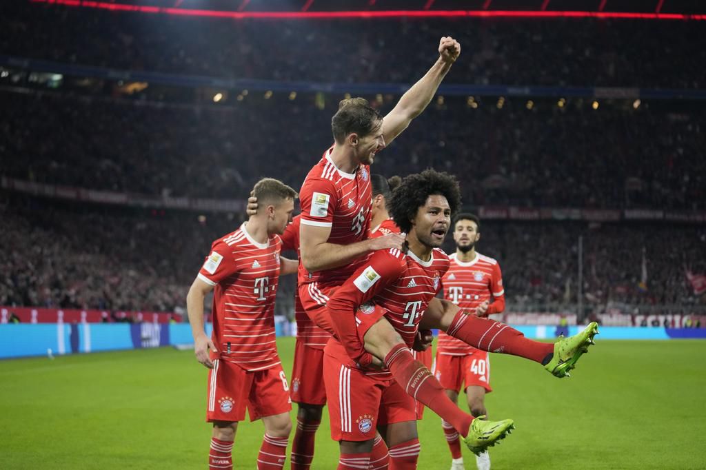 Hat-trick hero Gnabry celebrates with teammates.