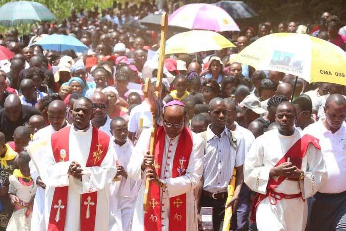 Nyeri Catholic Archbishop Antony Muheria carries a cross as led other faithful in a religious procession to Our Lady of Constanta Cathedral in Nyeri during a past event