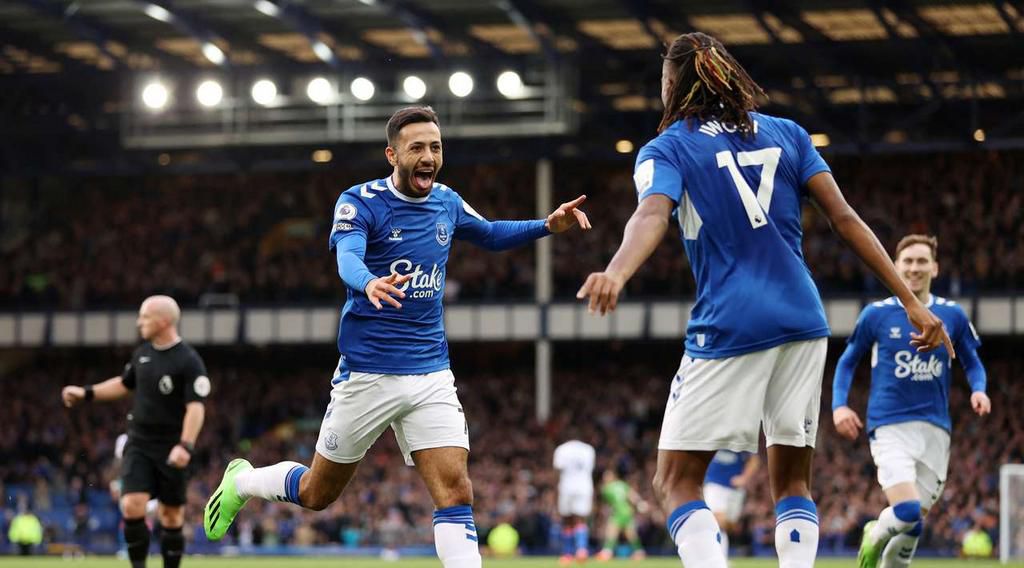 Alex Iwobi celebrates with Dwight McNeil after providing him with a nice pass inside the box to score Everton's third goal against Crystal Palace