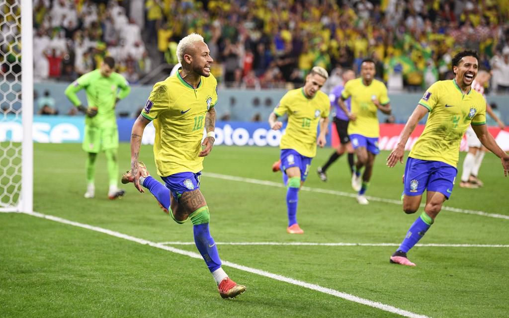 Neymar (front) celebrates with teammates after scoring the opening goal in the first half of extra time in a World Cup quarterfinal football match against Croatia at Education City Stadium on December 9, 2022.