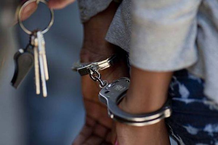 A woman in handcuffs