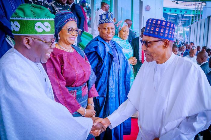 President Bola Tinubu (left) shakes hands with his predecessor, Muhammadu Buhari (right) [Presidency]