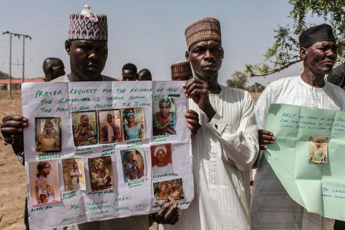 Parents and relatives hold portraits of their girls during a commemoration five years after they were abducted by Boko Haram Jihadists who stormed the Chibok girls' boarding school