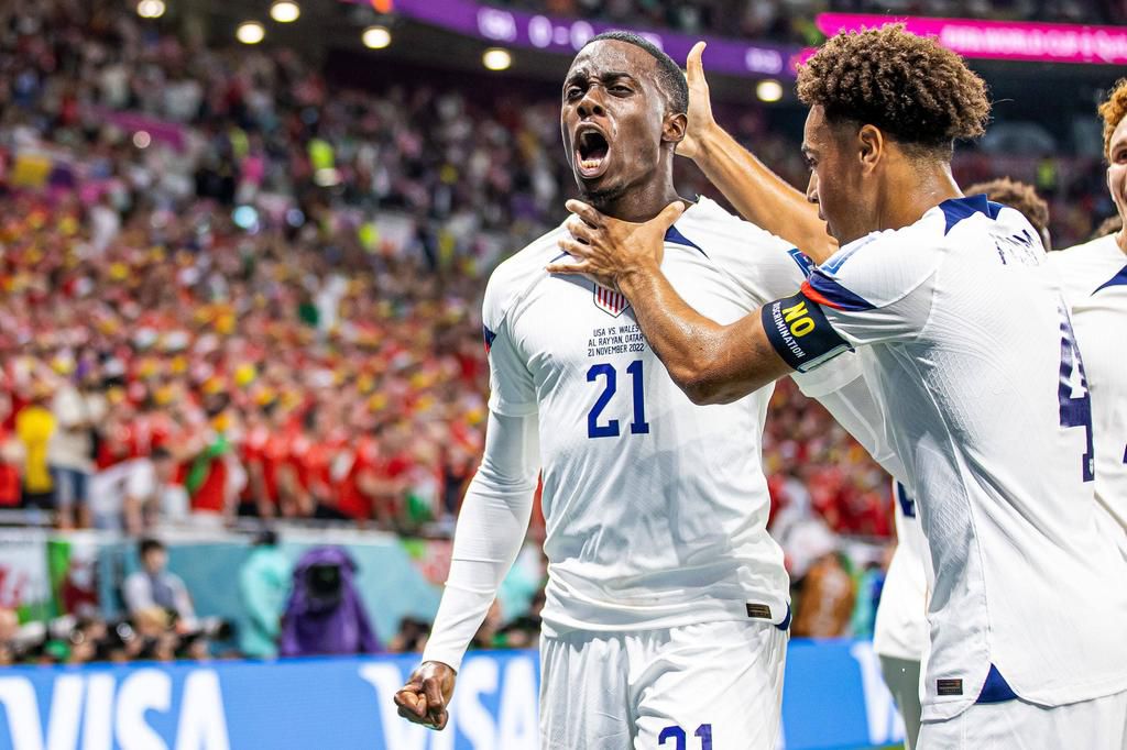 Timothy Weah (left) celebrates after scoring against Wales in the 2022 FIFA World Cup on November 21, 2022.