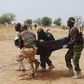 Nigerian soldiers carrying a fallen colleague.