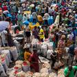 A sea of vendors and customers navigate Mile 12 International Market.