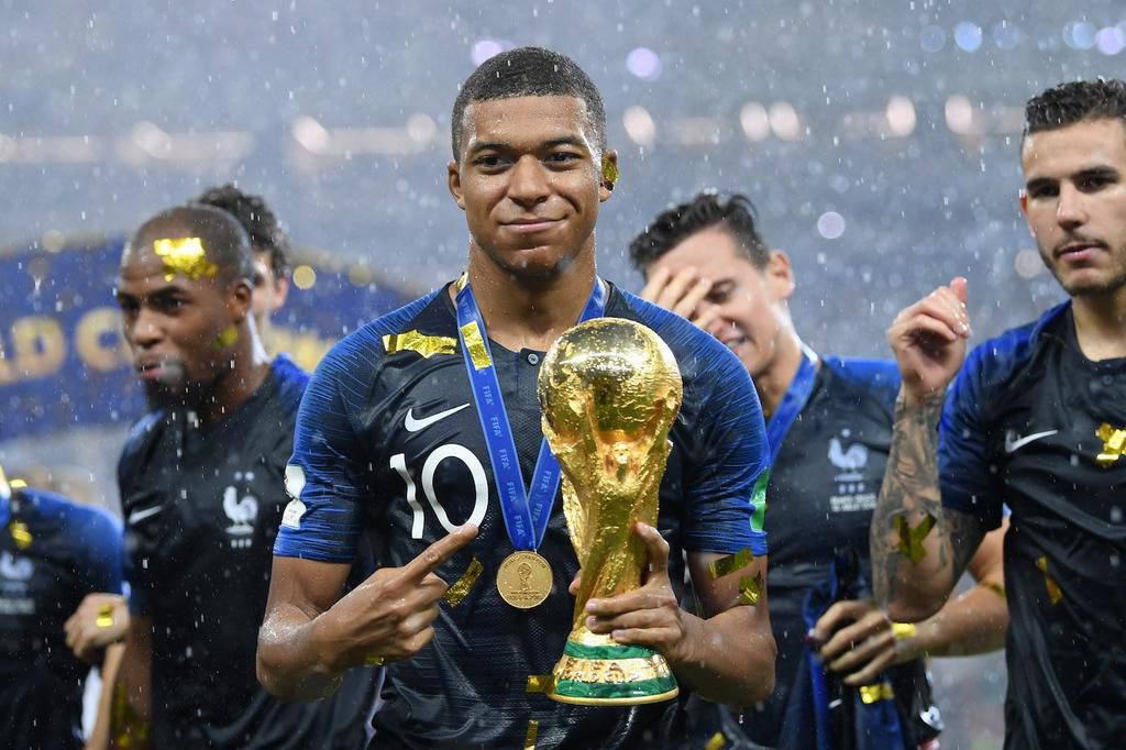 Kylian Mbappe of France celebrates with the World Cup trophy.
