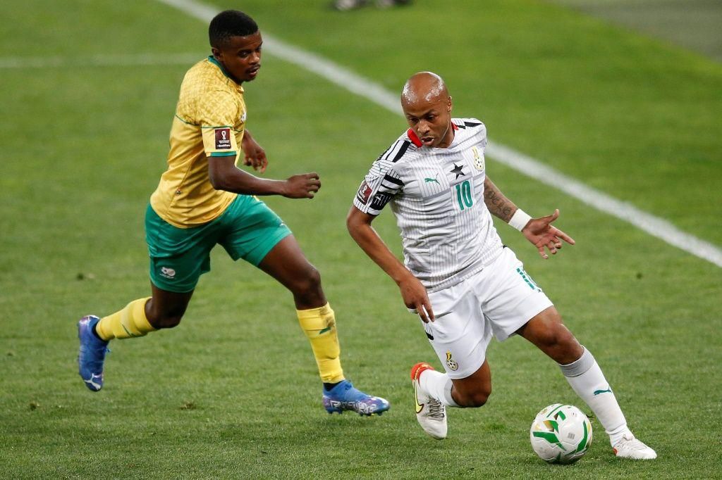 Ghana captain Andre Ayew (R) comes under pressure from South Africa midfielder Teboho Mokoena (L) during a World Cup qualifier in Johannesburg on Monday