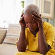 Distraught woman holds head in hands (image used for illustration) [iStock]