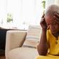 Distraught woman holds head in hands (image used for illustration) [iStock]