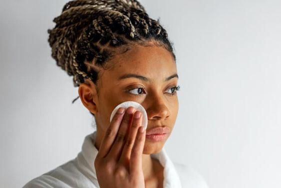 Woman using toner for face