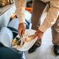 Man throwing left over food to a dustbin
