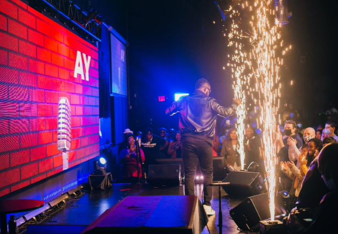 Ayodeji "AY" Makun during the performance of AY: Spotting the Difference [Instagram/@aycomedian]