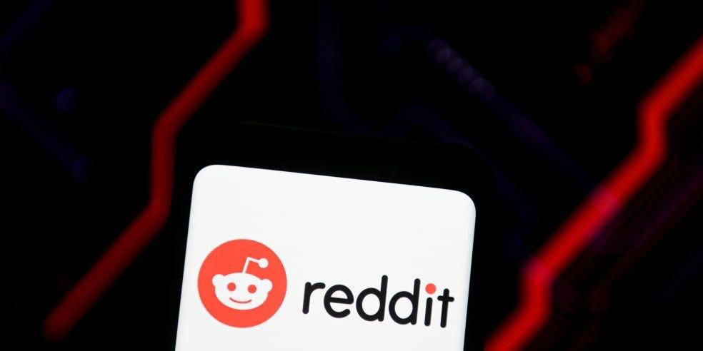 A Reddit logo is seen displayed on a smartphone.