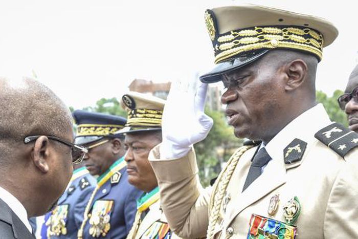 Head of Gabon’s elite Republican Guard, General Brice Oligui Nguema (R), is decorated by Gabon Prime Minister Alain Claude Bilie Bie Nze (L) in Libreville on August 16, 2023 during celebrations ahead of Gabon Independence day celebrated on August 17, 2...