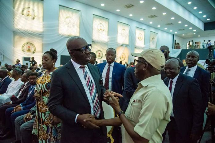 Gov.Godwin Obaseki of Edo chats with his predecessor, Sen. Adams Oshiomhole at the Alaghodaro Investment Summit in Benin [Twitter:@emmaikumeh]