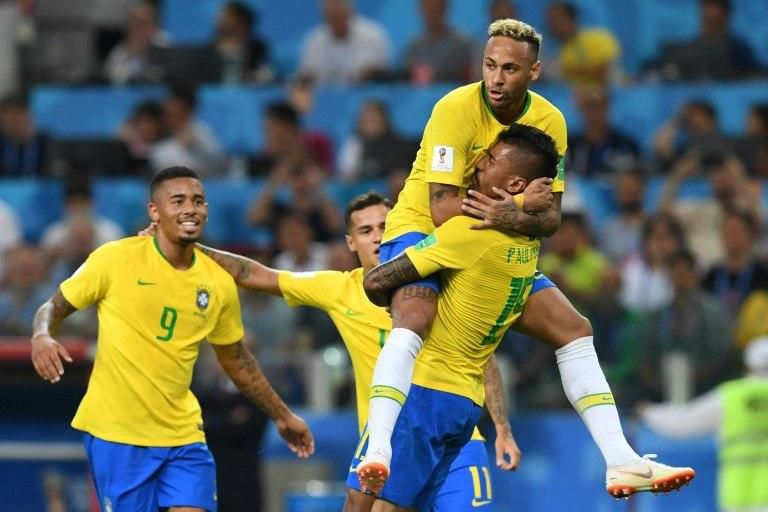 Brazil's midfielder Paulinho (R) celebrates with teammates Brazil's forward Neymar (top), Brazil's forward Gabriel Jesus (L) and Brazil's forward Philippe Coutinho after scoring during the Russia 2018 World Cup Group E football match between Serbia and...