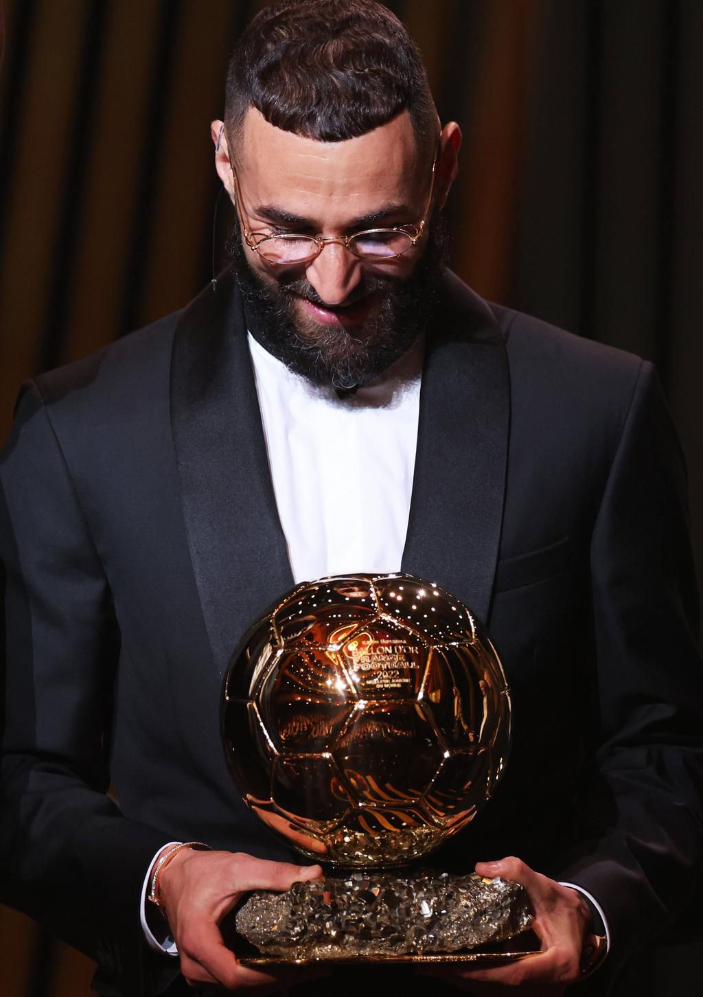 Real Madrid's French forward Karim Benzema reacts after receiving the men's Ballon d'Or Trophy during the 2022 Ballon d O'r awards on October 17, 2022.
