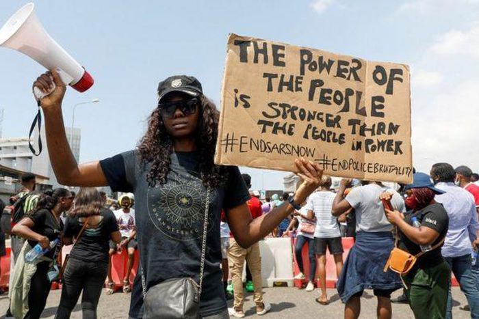 A young woman protesting against end sars [bbc]