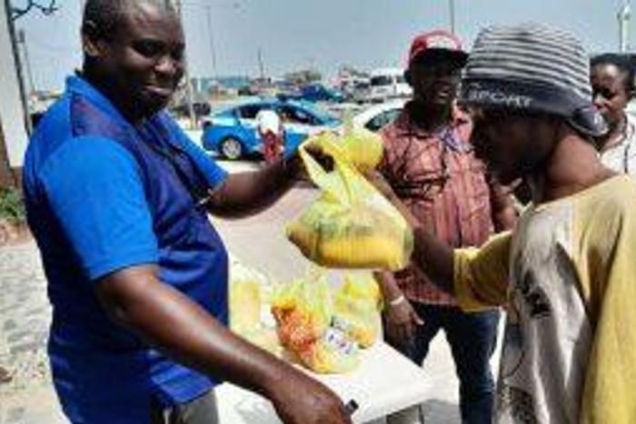 Mr Anthony Adeojo handing over a package to a beneficiary during the outreach to communities on Saturday. [NAN]