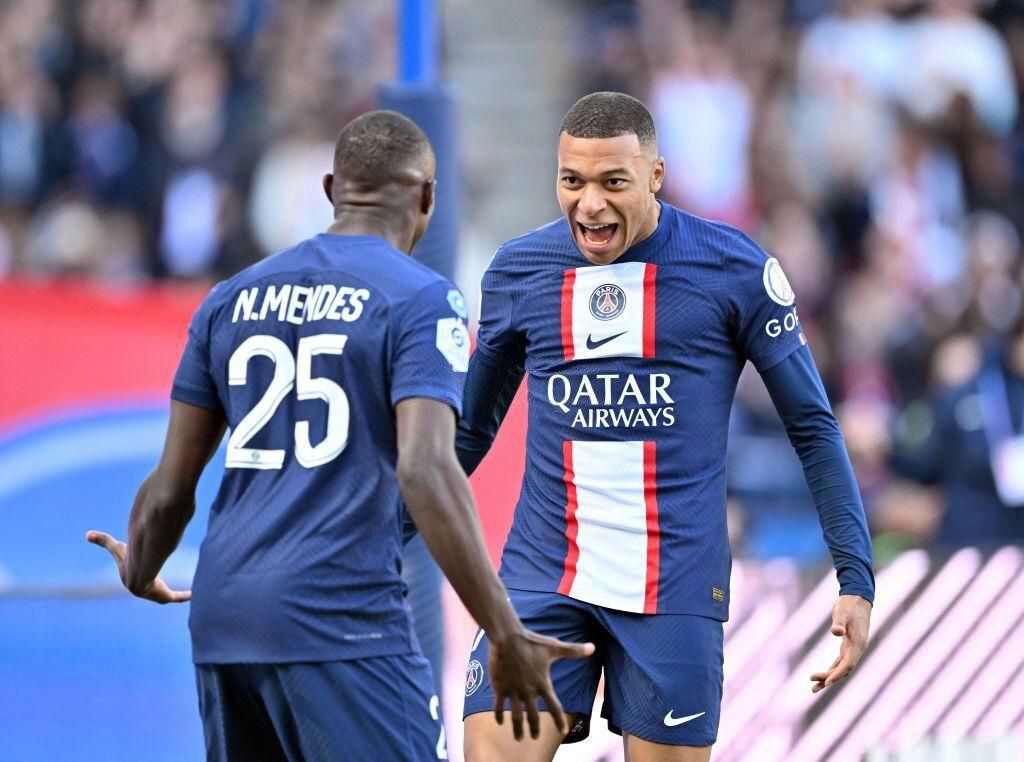Kylian Mbappe celebrates with Nuno Mendes after scoring for PSG