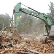 A bulldozer demolishing a building