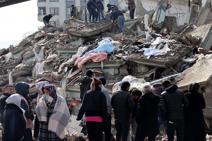 Rescuers and civilians look for survivors under the rubble of collapsed buildings in Kahramanmaras, Turkey. A 7.8-magnitude earthquake struck the country's southeast on February 7, 2023.ADEM ALTAN/AFP via Getty Images
