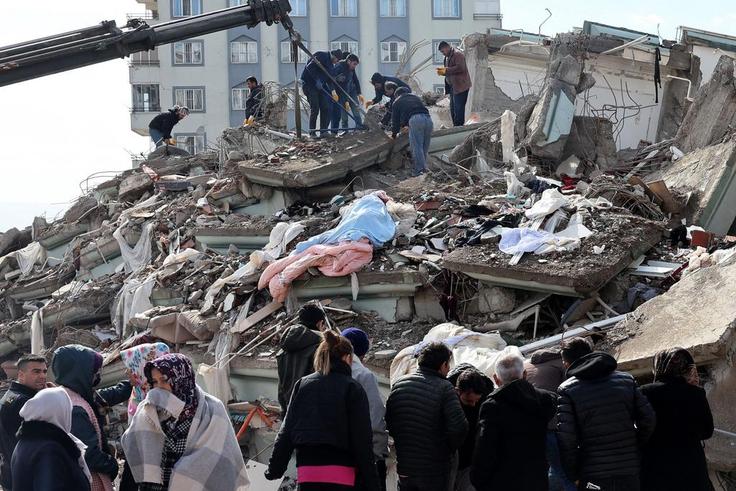 Rescuers and civilians look for survivors under the rubble of collapsed buildings in Kahramanmaras, Turkey. A 7.8-magnitude earthquake struck the country's southeast on February 7, 2023.ADEM ALTAN/AFP via Getty Images