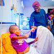 Lagos State governor, Babajide Sanwo-Olu, fistbumps boy with missing intestine, Adebola Akin-Bright [LASG]